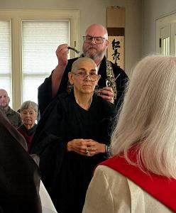 Rev. Jennifer Dressler of Open Table Church offers the Vow of Interfaith Cooperation during a Zen ordination ceremony at One River Zen in Ottawa, Illinois.