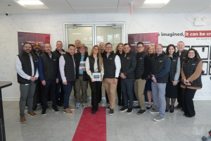 Eighteen people gather to officially open the company's Nieto-Jones Innovation Center