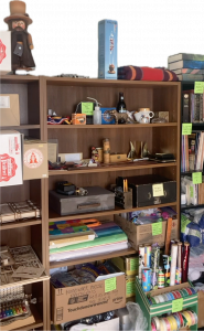 ‘Letting Go: The Ultimate Guide to a Guilt Free House Clean Out’, is packed with pragmatic tips and resource links, its purposeful design includes practical task sheets Bookshelves full of organized and labelled objects