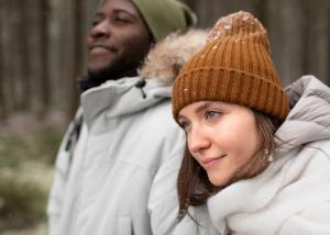 Happy couple walking together outdoors in winter clothing, illustrating the importance of social connections for mental wellness