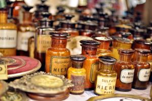 Archival photograph of antique glass medicine bottles used in historical apothecary and early medical practices.