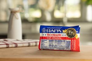 RAPA Scrapple commemorative packaging featuring a centennial logo celebrating the brand’s 100th anniversary in Delaware.