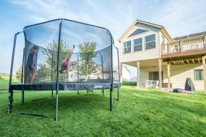 14ft Trampoline ACON UK in garden with children playing on it