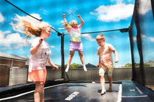 children playing on rectangle garden trampoline from ACON UK