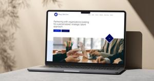 A laptop computer showing the Primary Talent Source recruiting firm homepage