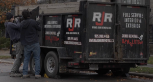 RJR team member hauling debris during a junk removal job.