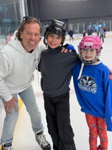 A REMAX Hendriks Team Realty representative and children participating in the Annual Free Family Skate Day in Thorold.