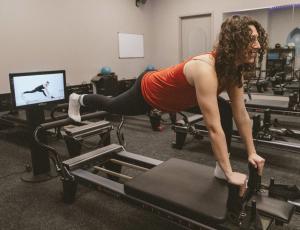 The Well Studio in the Tri-Valley is Investing in On-Demand Pilates for Functional Longevity 10 A Well Studio member using the KioskPro by Your Reformer in Dublin, California