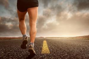 Athletic adult man running outdoors, representing improved stamina, vitality, and enhanced overall and intimate performance supported by Performance Center for Men.