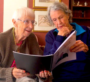 Two seniors enjoying a book
