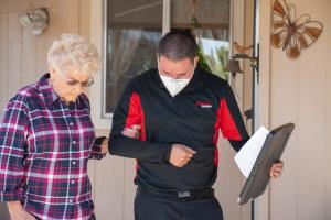 Amdal Transport Services employee assisting a client down stairs during non-emergency medical transportation in Tulare County, California