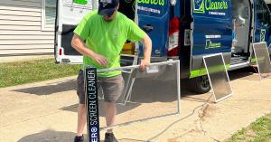 STL Window Cleaners technician using a screen cleaning system to wash window screens