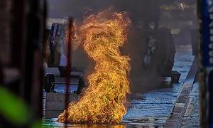 Flames emerging from a manhole in New York City; a relatively minor example of a manhole event when compared to the explosions that sometimes launch heavy manhole covers dozens of feet into the air.