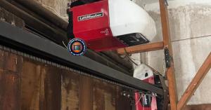 An On The Spot technician working on an emergency garage door repair at night in Downtown Long Beach 90802.