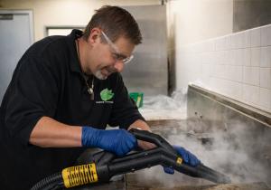 Margus Luik applies professional steam sanitation techniques to restore and maintain commercial kitchen safety standards.