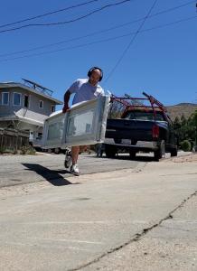 Professional technician performing garage door maintenance, inspecting torsion springs and adjusting hardware to ensure safe and reliable operation in San Luis Obispo County, California.