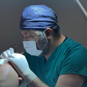 plastic surgeon dr alp aslan performing hair transplants