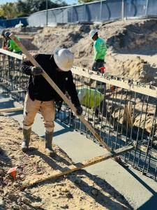 Construction worker preparing foundation footings at The Club at Mediterra Sports & Lifestyle Center in North Naples, Fla., expanding fitness, wellness, and social amenities.”