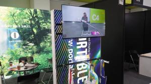 A scene from the booth of PortableX, playing a video on how to install its portable booth sytem