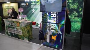 A scene from the booth of PortableX, showing recycled bags made from used booth materials.