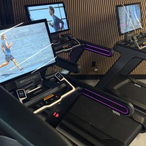 High-end treadmills with large streaming screens inside Granite Fit Club gym.