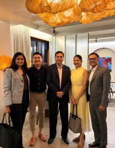 Healing Hands Clinic leadership and L Catterton representatives smiling together during a meeting to celebrate their $30 million investment partnership