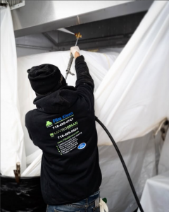 A Filta Kleen Hood Cleaning Specialist Cleaning a Commercial Air-Duct. inside of a commercial kitchen in NYC