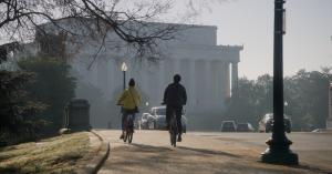 two people on bikes in shadow of Lincoln Memorial
