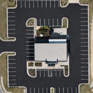 Aerial view of freshly paved commercial parking lot with clean striping in Columbus, GA completed by Chattahoochee Valley Sealcoating.