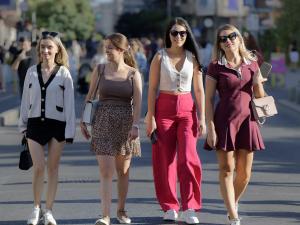 Group of empowered women walking outdoors, smiling and confident, representing satisfied YouShine Medspa patients.