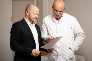 Healthcare provider at Mosaic Medicine discussing personalized hormone therapy plan with male patient in private consultation room.