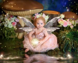 Young child in fairy costume during an Enchanted Fairies fine-art portrait experience, showcasing premium lighting and artistic studio design.