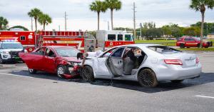 Two damaged vehicles positioned in a staged crash reenactment scene used for teen driving prevention education.