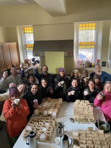 Boston School of Herbal Studies Students and Faculty raise a cup of tea after putting together over 200 bags of donated tea blends.