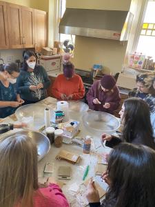 Boston School of Herbal Studies Students and Faculty label tea bags and prepare to mix tea for their annual donation workshop.
