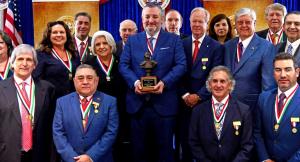 U.S. Sen. Ted Cruz holds a plaque recognizing him as the Washington’s Birthday Celebration Association’s 2026 Mr. South Texas, standing alongside past distinguished recipients and Laredo business leaders. Courtesy photo, Office of Sen. Cruz.
