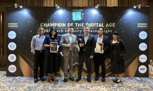 AC2 team stands smiling with awards at the "Champion of the Digital Age" event. Wining both Gold and Silver awards for AC2 Wave Warehouse Management System