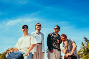 Official press portrait of Māori band SIX60, showcasing the 'Triumph of the Grassroots.' The image captures the band's family-orientated values (Whānau) and cultural resilience, serving as a visual response to the 2026 global language debates and the UNES
