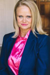 blond in blue biz suit