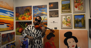 TERAVARNA’s opening night presentation at a physical art fair, showing visitors viewing a curated display of contemporary artworks at the gallery booth.