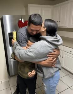 Self-employed family hugging inside their new home in San Antonio after successful home purchase
