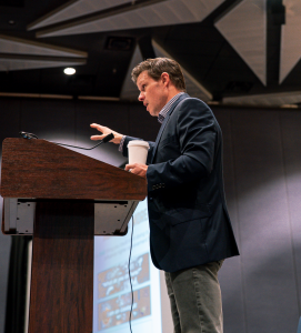 Two weeks after announcing its evolution from PRAX Leadership to PRAX Performance, PRAX is accelerating its expansion with the launch of a new division built specifically for high school, collegiate, and professional competitors: Athlete Andrew Geesbreght, Co-Founder of PRAX Performance, speaking at a podium during the Association of Chief Executives of Sport Conference in Fort Worth, TX.