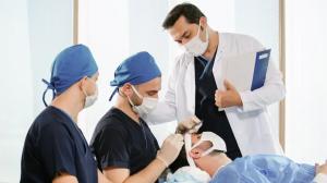 Dr Balwi and medical team with a hair transplant patient