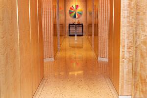 corridor with terrazzo floor and base and modern wood panel walls 