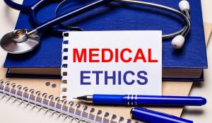 a photo of a table device with words on the screen in red letters Medical Ethics
