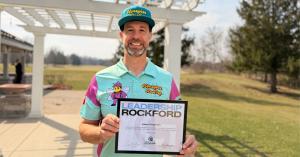 Adam Rossman President of Honeybee Roofing Standing Outside the Celebration of Leadership Event With His Newly Received Certificate