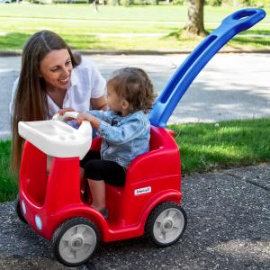 Simplay3 Celebrates American Manufacturing with Limited Edition Series 15 A mom kneeling next to her daughter as she sits in a red toy car.