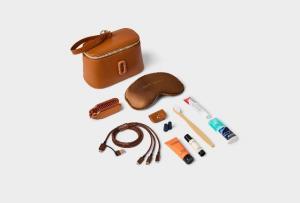 Business class amenity kit designed by Marc Jacobs, featuring a leather pouch, eye mask, charging cables, and travel essentials