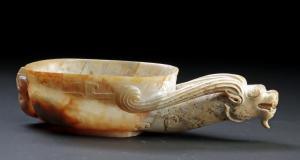 Chinese carved jade cup of elongated form, from the Warring States period, circa 475-to-221 BCE; a shallow, oval vessel worked from pale white jade. Museum-exhibited. Sold for $19,500