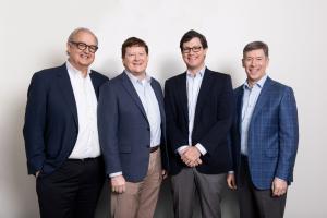 Four Diversified Trust leaders pose together following the firm’s announcement of planned CEO and president successions.